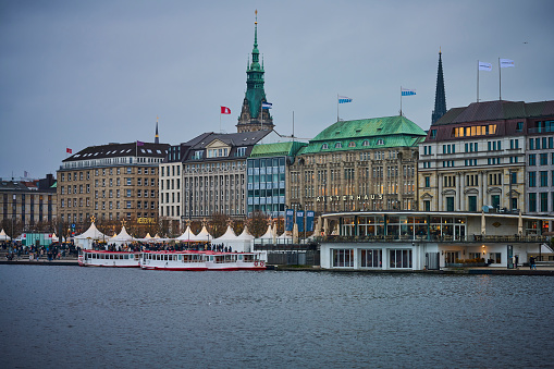 Christmas market in Hamburg at lake Binnen Alster. View from lake side. Hamburg is known for impressive Christmas markets. One is located at Jungfernstieg along the lake side.