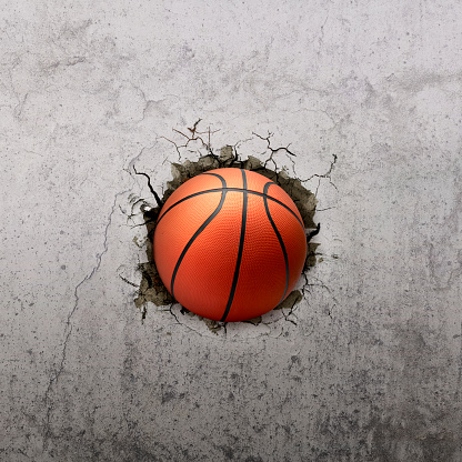 Basketball ball flying through the wall with cracks