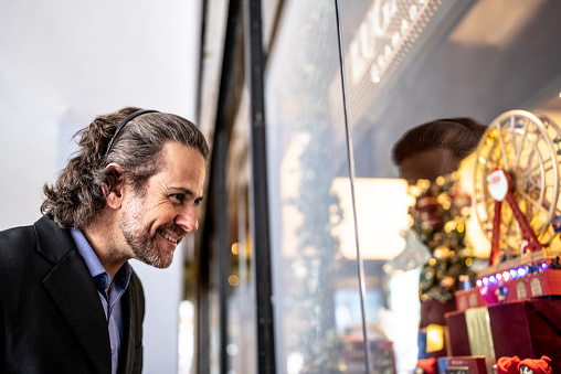 Business mature man looking the store window