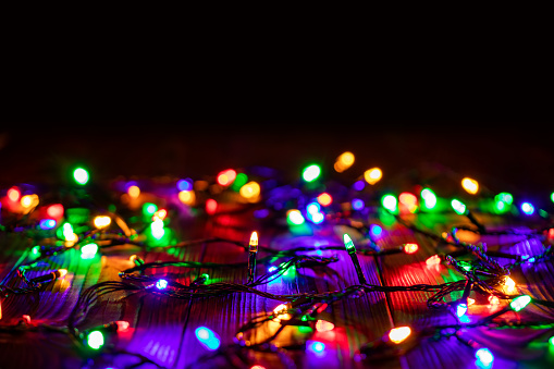 A mini Christmas tree is surrounded by small stars and lights and a bokeh in the background, 3d rendering
