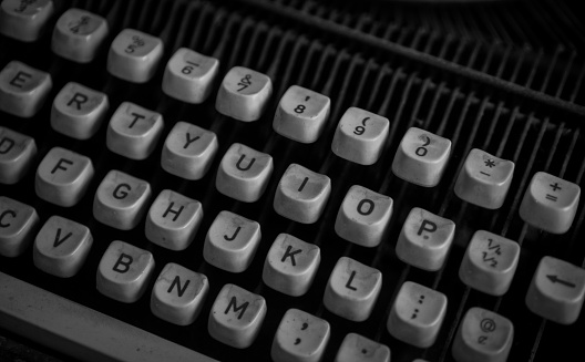 writer's workplace - wooden desk with vintage typewriter