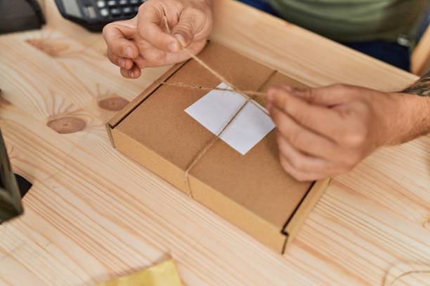 istock Young redhead man business worker prepare order package at office 1446883818