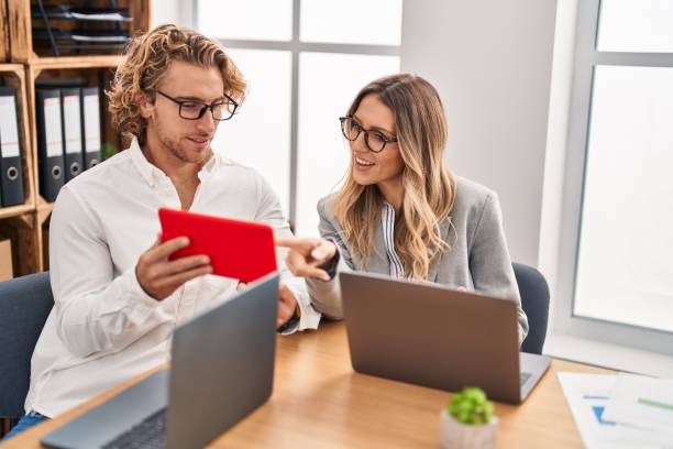 istock Man and woman business workers working using laptop and touchpad at office 1446884044