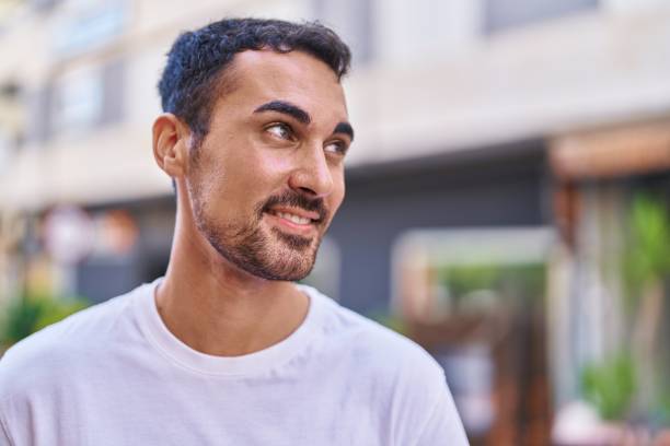 istock Young hispanic man smiling confident looking to the side at street 1446884258