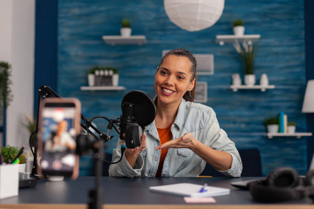 istock Smiling influencer recording mouse review with smartphone. 1446884324
