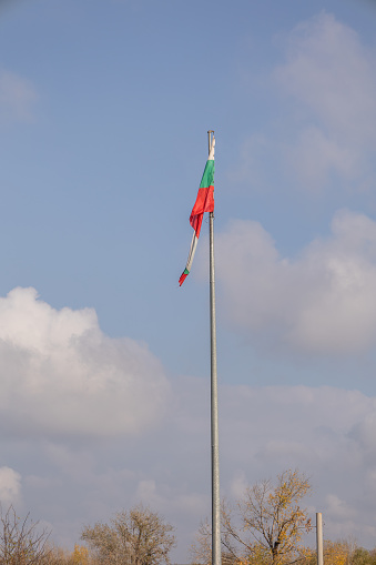 Bulgarian flag with blue cloudy sky