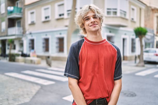 istock Young blond man smiling confident standing at street 1446884634