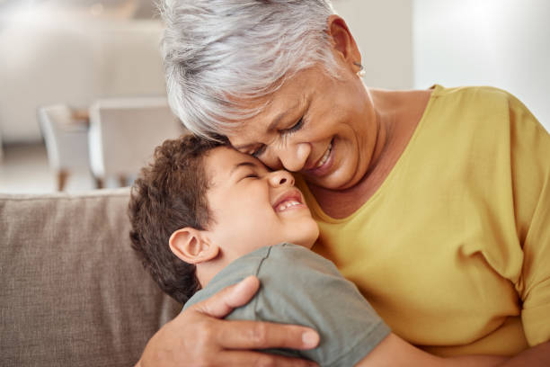 happy family, child and grandma hug and bond in living room together, happy and content in their home. relax, smile and love of boy hugging senior woman showing love and having fun in brazil house - latin american and hispanic ethnicity senior adult mature adult couple imagens e fotografias de stock