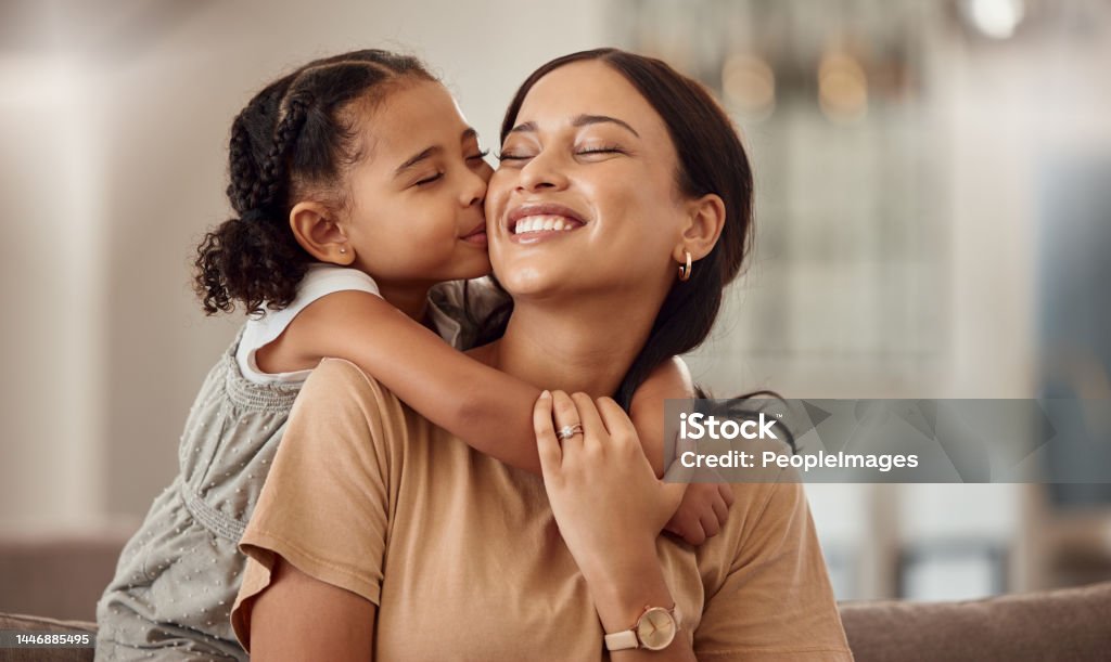 Happy, kiss and hug on mothers day in living room sofa, love and relaxing together in Australia family home. Young girl, smile parent and happiness, quality time and care on lounge couch for fun Mother Stock Photo