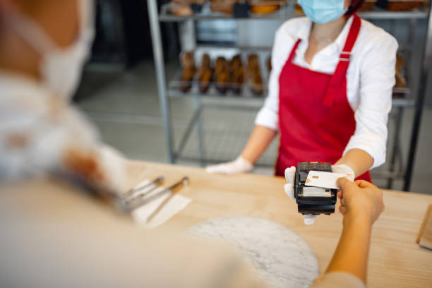 istock Customer buying and contactless paying in bakery 1446885633