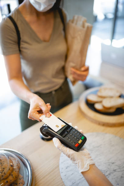 istock Customer buying and contactless paying in bakery 1446885673