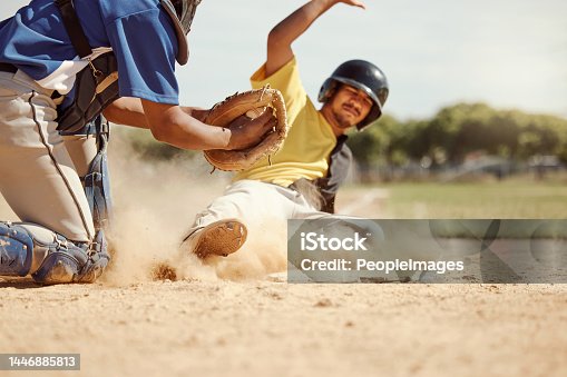 istock Baseball player, run and slide in dirt for game, contest or match on field, pitch or stadium. Man, baseball and dust in sand for sports to reach base fast for win, competition and sport in summer 1446885813