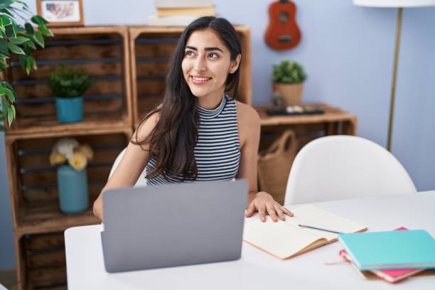 istock Young hispanic girl smiling confident studying at home 1446885964