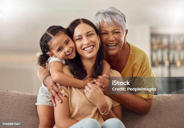Grandmother Mom And Child Hug In A Portrait For Mothers Day On A House Sofa As A Happy Family In Colombia Smile Mama And Elderly Woman Love Hugging Young Girl Or Kid And Enjoying Quality Time Stock Photo - Download Image Now