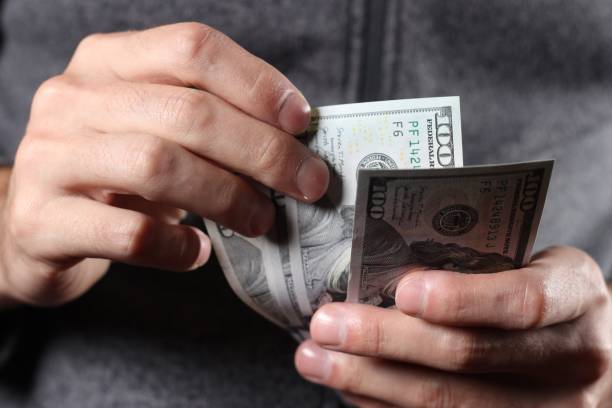 istock American 100 dollars bank note in hand close up 1446888102