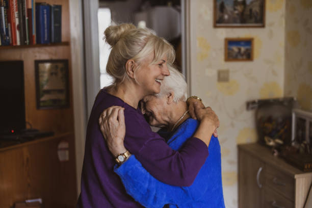 istock Woman hugging her elderly mother 1446888330