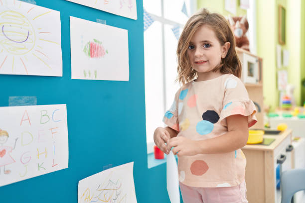 istock Adorable hispanic girl smiling confident standing at kindergarten 1446888404