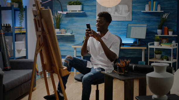 istock African american adult using smartphone for drawing process 1446889420