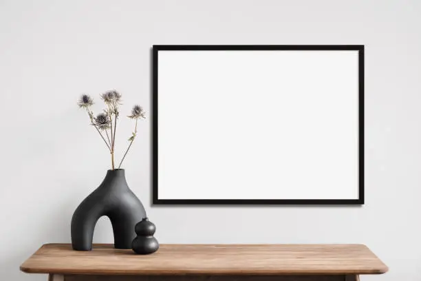 Photo of Artwork mockup in interior design. Blank picture frame on a wall