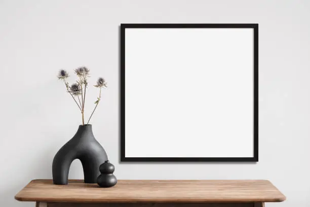 Photo of Artwork mockup in interior design. Blank picture frame on a wall
