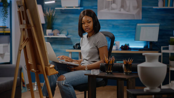 istock African american artist typing on laptop computer at studio 1446890929