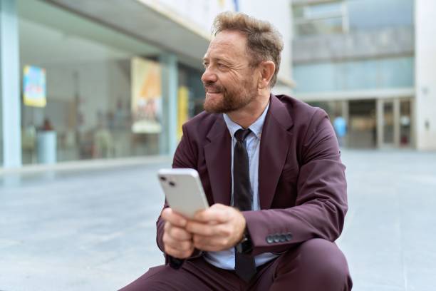 istock Middle age man business worker using smartphone sitting on stairs at street 1446891390