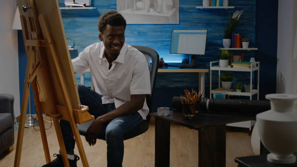 istock African american adult sitting in artwork studio drawing 1446891689