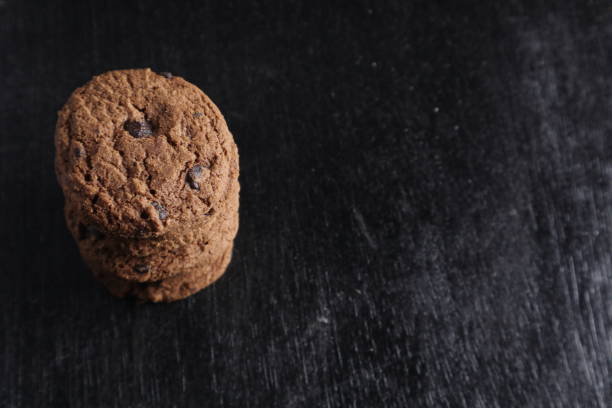 istock Chocolate chip cookies on black background 1446893194