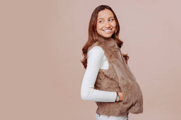 Young multiracial positive woman posing at studio