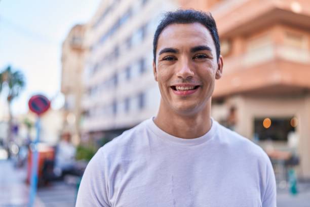 istock Young hispanic man smiling confident standing at street 1446894251