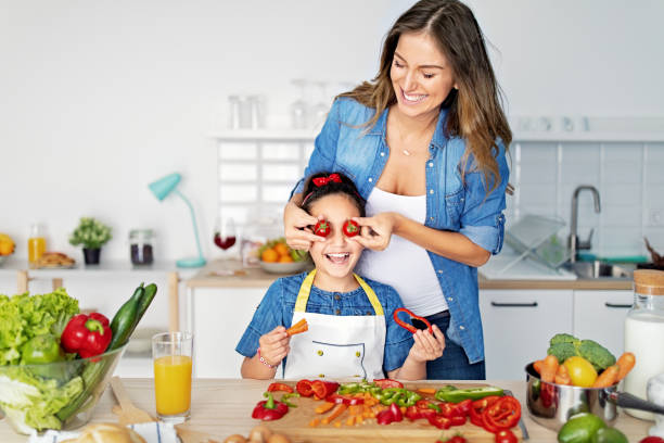istock Mother and daughter cooking together in a kitchen 1446896577