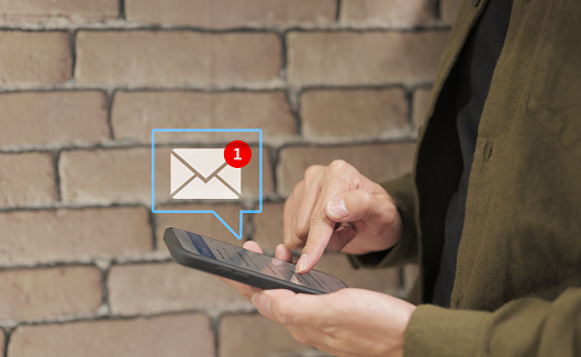 Communication business technology concept. Businessman hand holding use smartphone with new email alert sign icon pop up to send or read email. connection message to global letters. receive newsletter