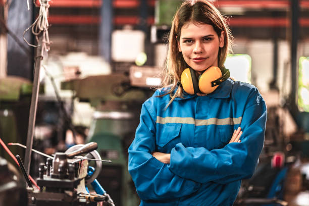 istock Young people worker in protective uniform operating machine at factory Industrial.People working in industry.Portrait of Female Engineer looking camera at work place. 1446897819