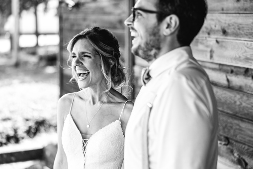 black and white photo of laughing bride and groom