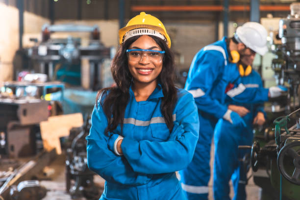 istock Young people worker in protective uniform operating machine at factory Industrial.People working in industry.Portrait of Female Engineer looking camera at work place. 1446897874