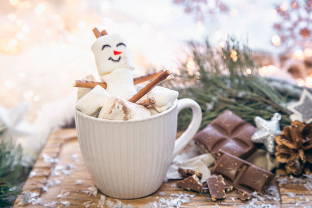 istock Christmas background with marshmallow snowman in a cup. 1446898048