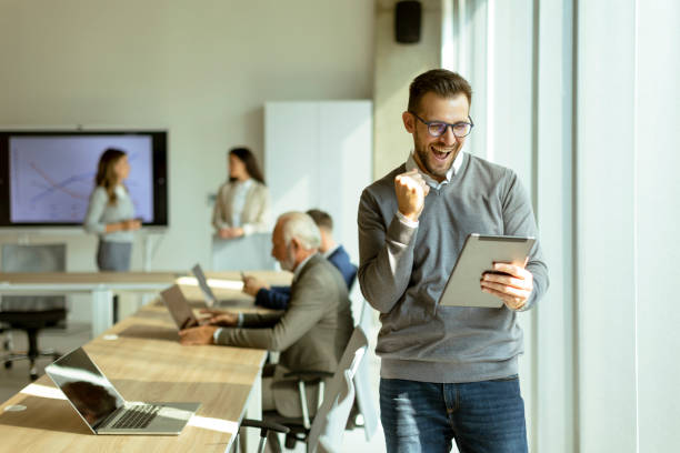 istock Young modern businessman using digital tablet in the office 1446900976