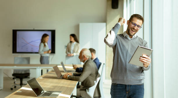 istock Young modern businessman using digital tablet in the office 1446900980