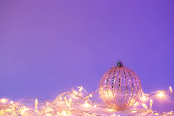 istock Christmas tree ball and garland in neon light isolated, copy space. 1446901267