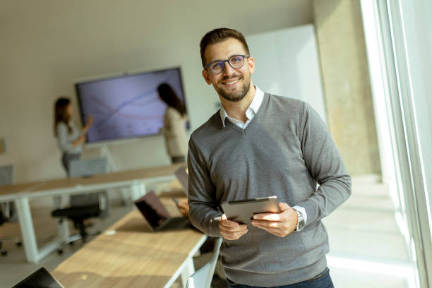istock Young modern businessman using digital tablet in the office 1446901511