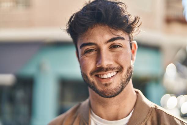 istock Young hispanic man smiling confident standing at street 1446902652