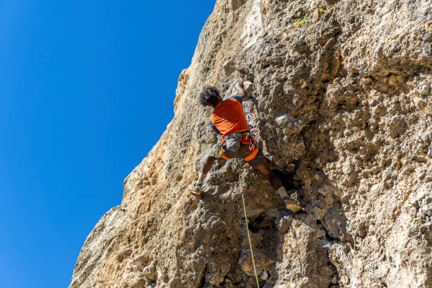 young climber is  climbing on the vertical rock in Antalya stock photo