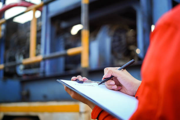 istock Writing on the preventive maintenance checklist of the heavy machine. 1446902910