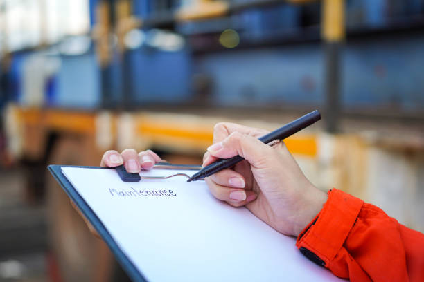 istock Writing on the preventive maintenance checklist of the heavy machine. 1446902914