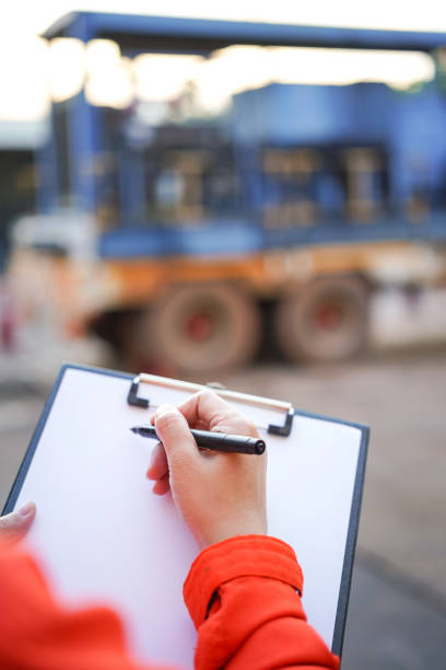Writing on the preventive maintenance checklist of the heavy machine.