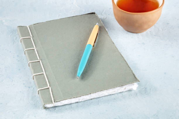 istock Diary. A handmade journal with a pen and a cup of tea 1446903887