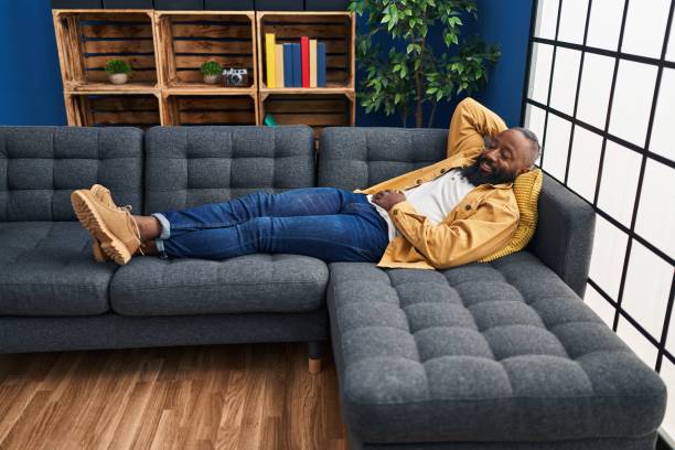 istock Young african american man smiling confident relaxed lying on sofa at home 1446905703