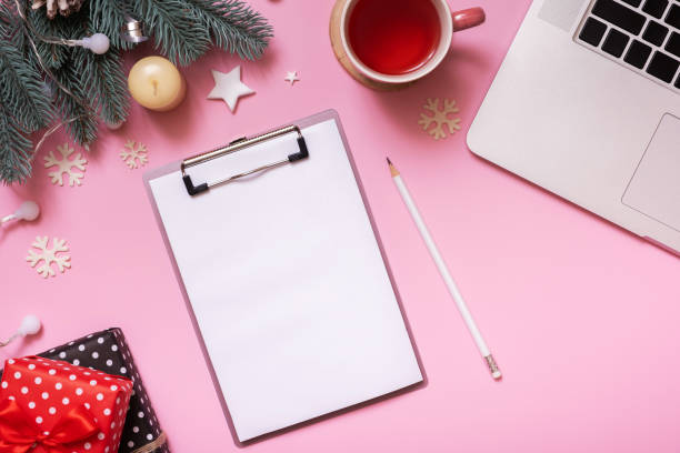istock Blank note paper on tablet and Cristmas New Year work table decoration top view, flat lay on pink background 1446908174