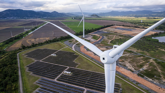 field of wind turbines in sunset in spring