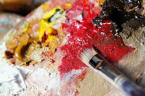 Paintbrush in action mixing colors.